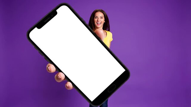 Smiling young woman presenting a blank screen phone mockup for your app or website display needs, ready for content