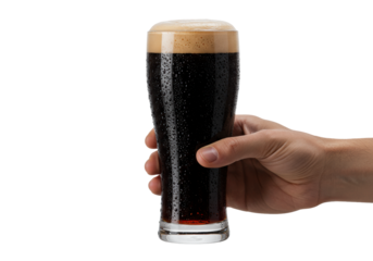 adult male hand holding a macro shot of rich dark stout beer in a stemmed glass, exhibiting condensation and creamy overflowing foam on transparent. concept for beverage advertising