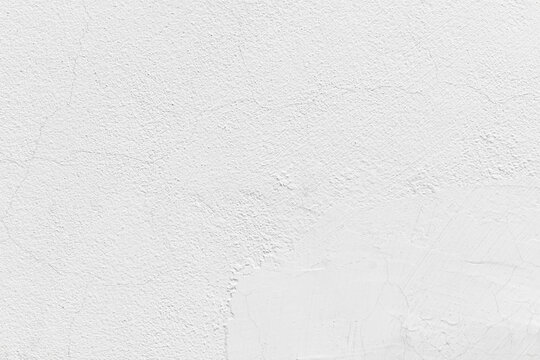 Uneven render white wall with dirty brown stain. Stucco paint plaster grunge and rough surface. Filler on concrete wall.