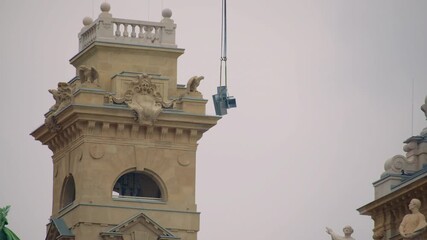 Close view of construction crane and architectural details highlighting restoration process