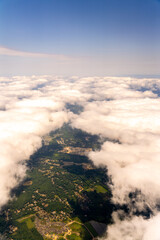 Fototapeta premium Aerial view of clouds over suburban landscape and construction site.