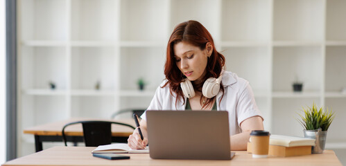 Caucasian woman girl take work break at office relaxed businesswoman smile listen music in headphones on laptop online musical service business manager listening in earphones enjoy melody dancing move