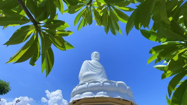 Nha Trang, Vietnam - September 18, 2025. Chua Long Son Pagoda with a large white Buddha statue in the vast, clear blue sky. The main Buddhist temple of Kien Giang Province. 4К
