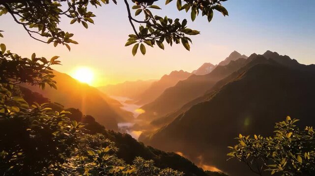 Stunning view of sun rising over layered mountain range with valley fog illuminated by golden light seen through foreground tree foliage