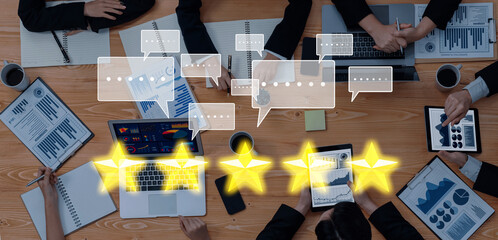 A diverse business team collaborates in a modern office setting, analyzing statistics and discussing project management while utilizing digital devices for effective communication. Trope