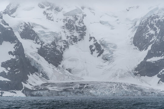 Antarctica Glacier and Snow Covered Mountains in Elephant Island Close Up. Frozen Landscape Ice and Ocean Water View From Ship