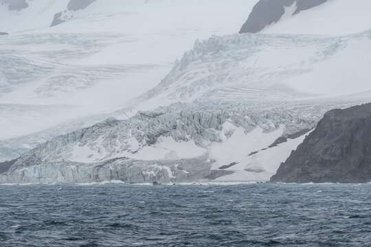 Antarctica Beautiful Glacier and Snow Covered Mountains in Elephant Island Close Up. Frozen Landscape Ice and Ocean Water View From Ship