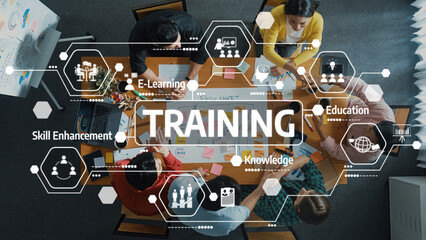 A diverse team collaborates in a training session, focusing on skill enhancement and e-learning, fostering innovation and teamwork in a modern educational setting. Amity