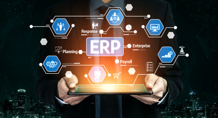 A businessman holds a tablet displaying various icons representing ERP systems, highlighting enterprise resource planning and digital innovation in modern businesses. Tessel