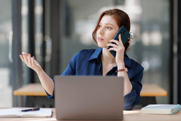 Laptop, mature woman and phone call for client feedback, venue booking and remote work. Freelancer,...