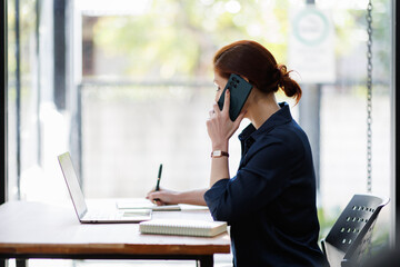 Laptop, mature woman and phone call for client feedback, venue booking and remote work. Freelancer,...