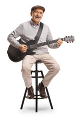 Obraz premium Happy senior man sitting on a stool and playing an electric guitar