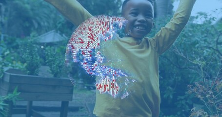Smiling child in yellow long-sleeve shirt raising arms in garden, with digital blue-red-white swirl