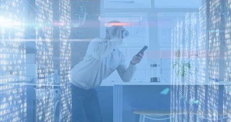 Leaning man in light top, holding smartphone with VR headset at home kitchen, showing digital code