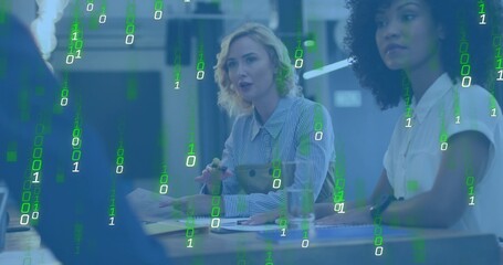 Discussing two biz-casual women leading meeting at office table with notes and pens, binary overlay