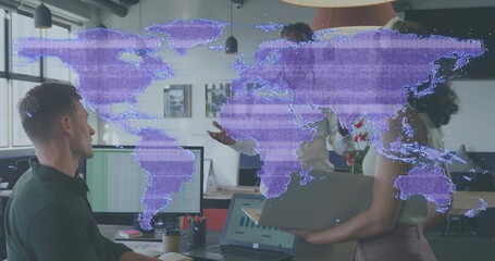 Showing team meeting in office, woman in sleeveless top holding laptop with purple map overlay