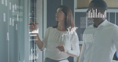 Pointing woman, coworker in businesswear analyzing glass wall with sticky notes, red marker, charts