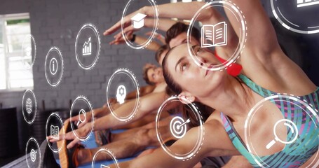 Stretching woman in striped bra doing side reach in fitness studio, with yoga mats, digital icons