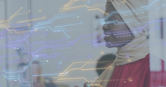 Speaking woman wearing beige hijab and red top leading office meeting, digital overlay, copy space - Powered by Adobe