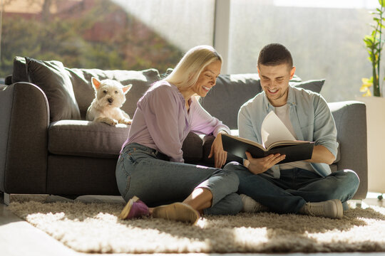 Young couple relaxing at home and reading