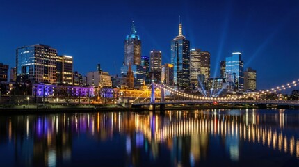 Vibrant Melbourne Skyline At Night With Glowing Skyscrapers Reflected In The Yarra River Under A Deep Blue Sky With Radiant Searchlights