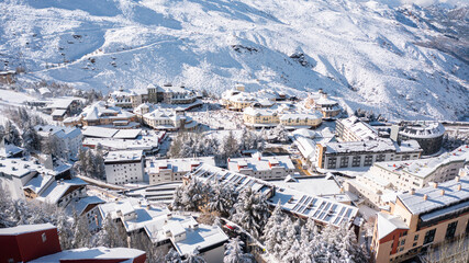 Aerial photo from dronet to Sierra Nevada ski resort on a sunny winter day in the mountains, Spain. Sierra Nevada is the largest mountain range near the city of Granada in Spain with snow. Sierra Neva