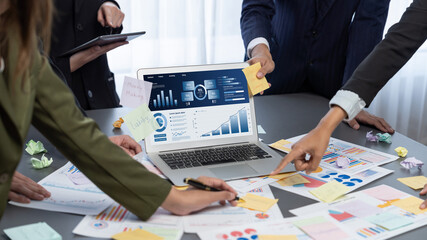 Analyst team use sticky note for creative and analytic brainstorm for business idea with BI data dashboard on laptop screen. Analysis financial data visualization tech for marketing strategy. Prodigy