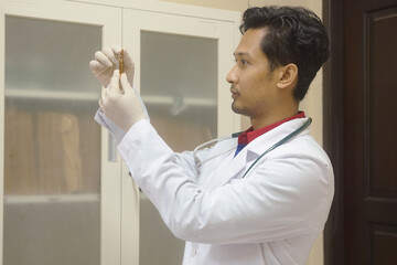 Medical Professional Examining a Vial in a Clinic Setting