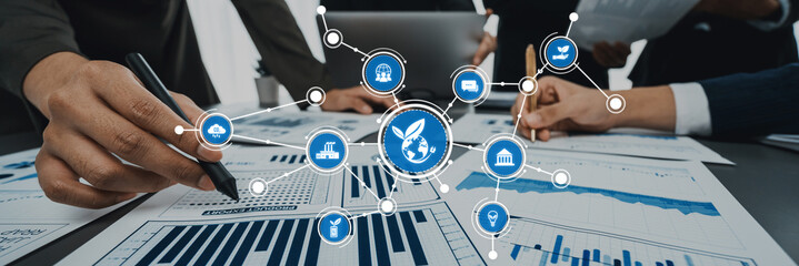 Collaborative analysis in a corporate environment showcasing team members working on financial graphs and data visualization to drive strategic decisions and insights. Amity