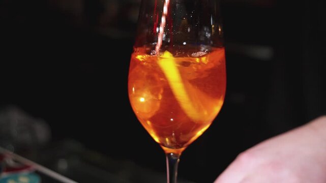 Bartender working, beautiful row line of different coloured liquor alcohol cocktails on a party in a bar, catering banquet on event, barman mixing drinks, selection of beverages in a restaurant club
