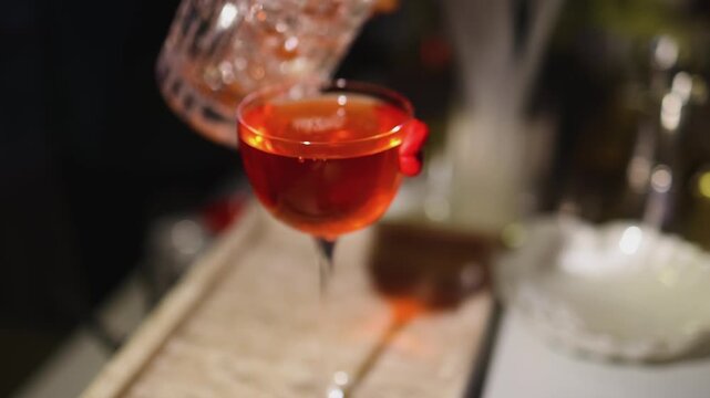 Bartender working, beautiful row line of different coloured liquor alcohol cocktails on a party in a bar, catering banquet on event, barman mixing drinks, selection of beverages in a restaurant club