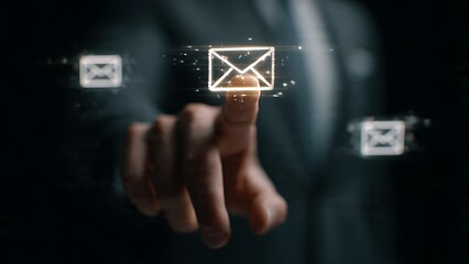 Professional businessman's finger touches glowing digital envelope icon, symbolizing communication and sending messages in a modern, abstract interface
