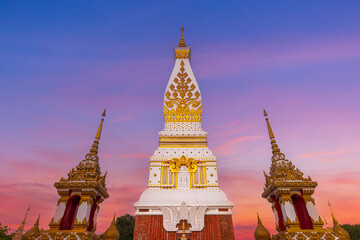 Fototapeta premium Golden Pagoda of Wat Phra That Phanom at Twilight with Ornate Temple Gates, Nakhon Phanom, Thailand.