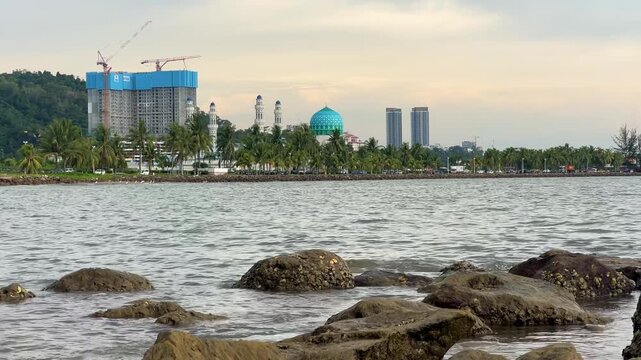 Malaysia, June 31, 2025: The Masjid Bandaraya City Mosque in Kota Kinabalu, Sabah. View of the floating mosque from Likas Bay Beach on the South China Sea. 4K