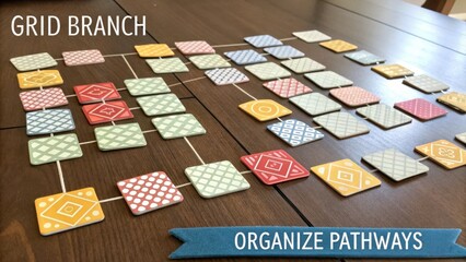 Colorful grid branch game layout demonstrating organized pathways and spatial arrangement on a wooden table surface