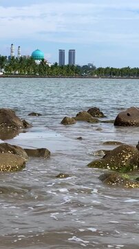 Malaysia, June 31, 2025: The Masjid Bandaraya City Mosque in Kota Kinabalu, Sabah. View of the floating mosque from Likas Bay Beach on the South China Sea. 4K