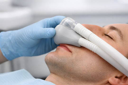 Dental Professional Holding Sedation Mask