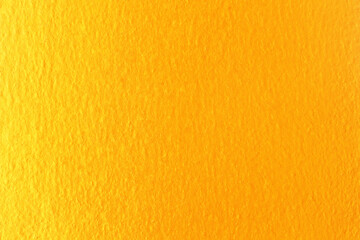 Obraz premium Gold or yellow paint on cement wall texture background.