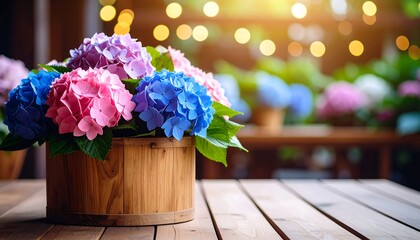 A vibrant display of colorful hydrangeas in a wooden planter sits on a wood table, bokeh background