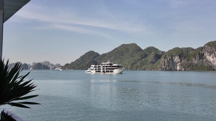 Ha Long Bay's iconic mountains are actually dramatic limestone karst formations, remnants of ancient mountains eroded over millions of years, jungle-covered mountains, ships and boats afloat