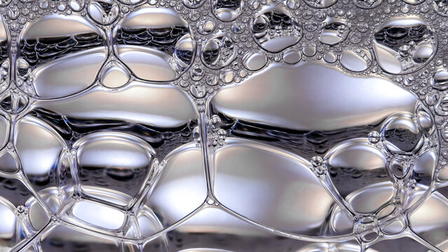 Abstract macro view of glossy bubbles and silky liquid textures, symbolizing hydrated skin, deep moisture, and smooth beauty serum surfaces with a clean background, luminous, and premium skincare aest