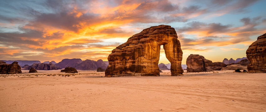 Dramatic Sunset Sky over Iconic Elephant Rock (Jabal AlFil) in AlUla, Saudi Arabia Desert Landscape