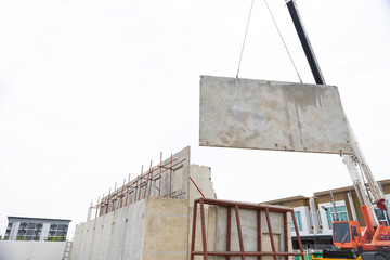 Background banner. Large cranes moving prefabricated walls in factories. Prefabricated concrete walls for building office buildings and residential houses. reinforced concrete wall