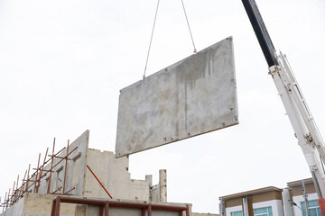 Background banner. Large cranes moving prefabricated walls in factories. Prefabricated concrete walls for building office buildings and residential houses. reinforced concrete wall