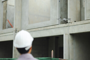 Industrial drone operators. Construction drone fly over house building site photography. innovative technology. Specialists Pilot Drone on Construction Site