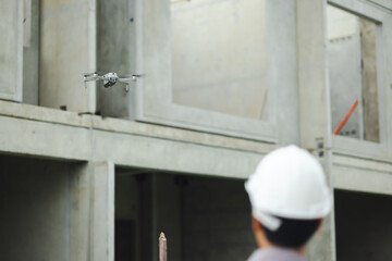 Industrial drone operators. Construction drone fly over house building site photography. innovative technology. Specialists Pilot Drone on Construction Site