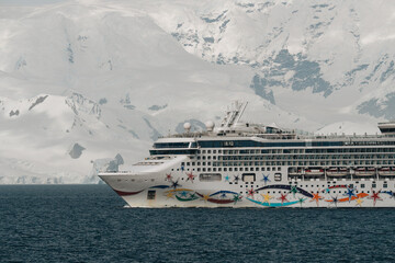 Dec 23, 2025, Antarctica: Close Up Cruise Ship Explores Peninsula with Huge Mountains of Snow and...