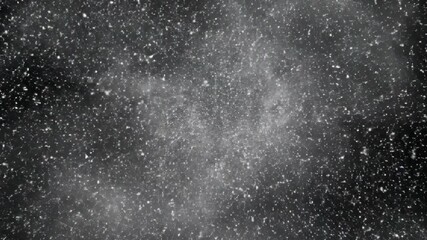 Gritty, chaotic gray dust particles and debris exploding in a centrally lit cloud against a dark background, creating an intense, abstract atmospheric grunge texture. - Powered by Adobe