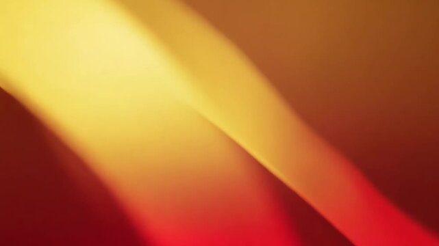 Abstract orange and yellow gradient background with smooth curves and light effects, possibly used for design or advertising