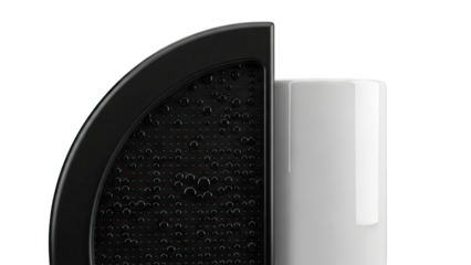 Close-up of a black textured surface with water droplets and a white cylinder